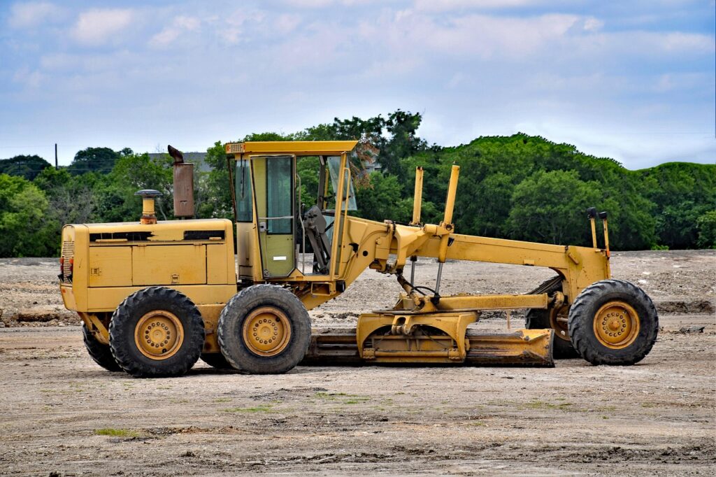 grader, machinery, animal, construction, yellow, heavy, road, vehicle, equipment, scraper, roadwork, industrial, technology, pet, hydraulic, power, blade, wheel, landfill, cat, work, industry, machine, engineering